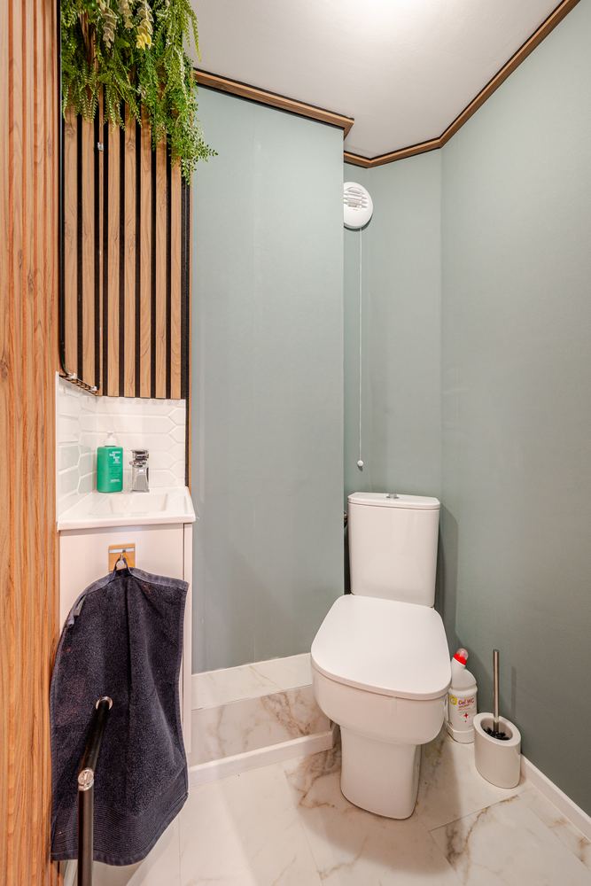 Separate toilet with green panelling