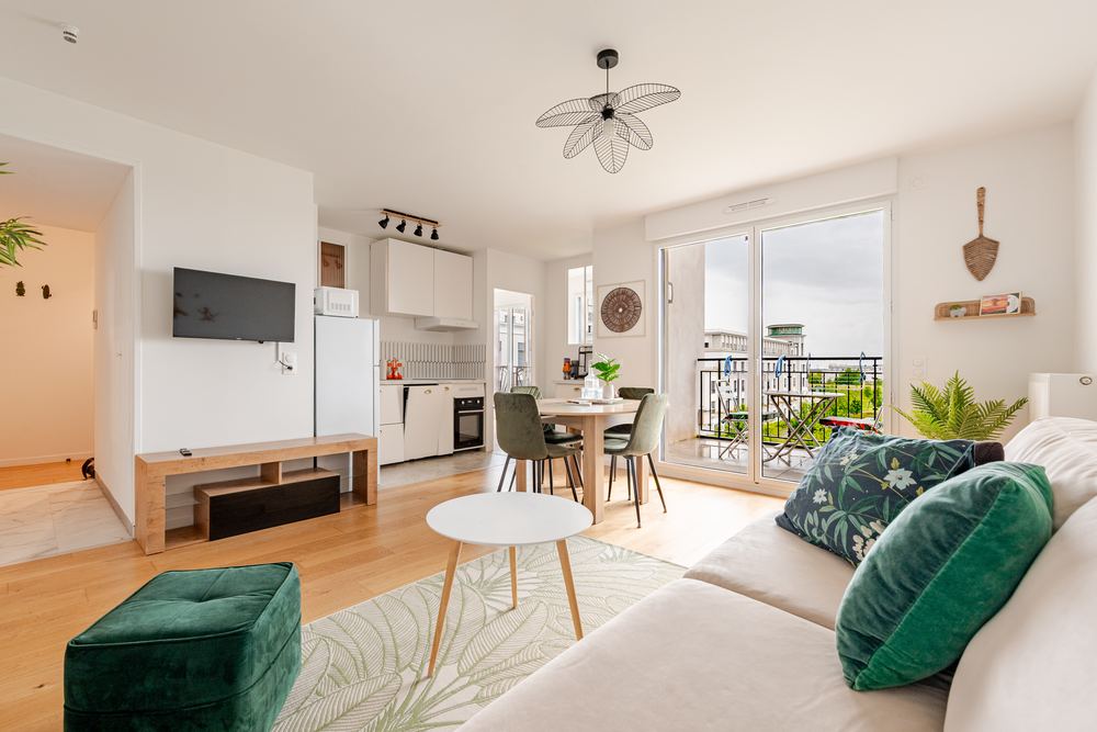 Living room with TV wall and open kitchen