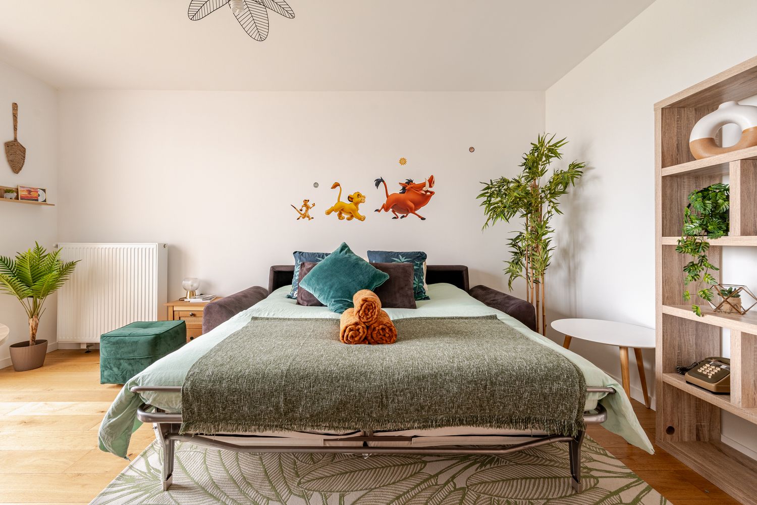Lion King wall decals and Disney books in bedroom 2 of The Lion Suite