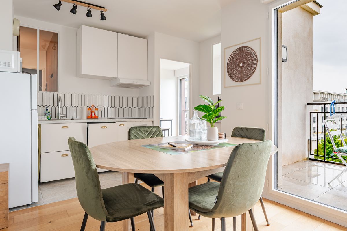 Living room, dining table and open kitchen with balcony